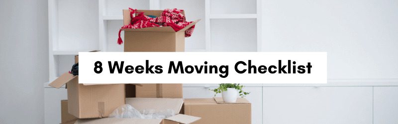 Cardboard boxes stacked in a room, with a plant and a colorful blanket visible, alongside a text overlay for an 8-week moving checklist.