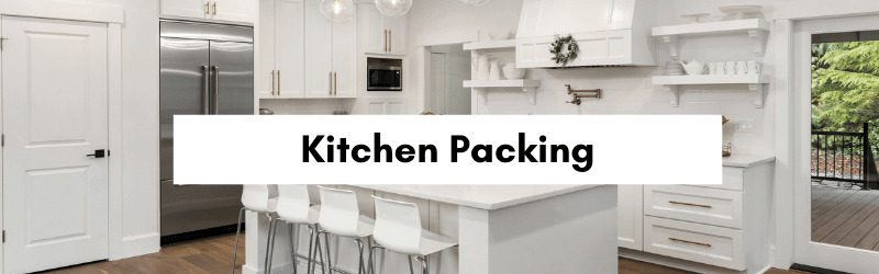 Modern kitchen with white cabinetry, stainless steel appliances, and a large island with bar stools.