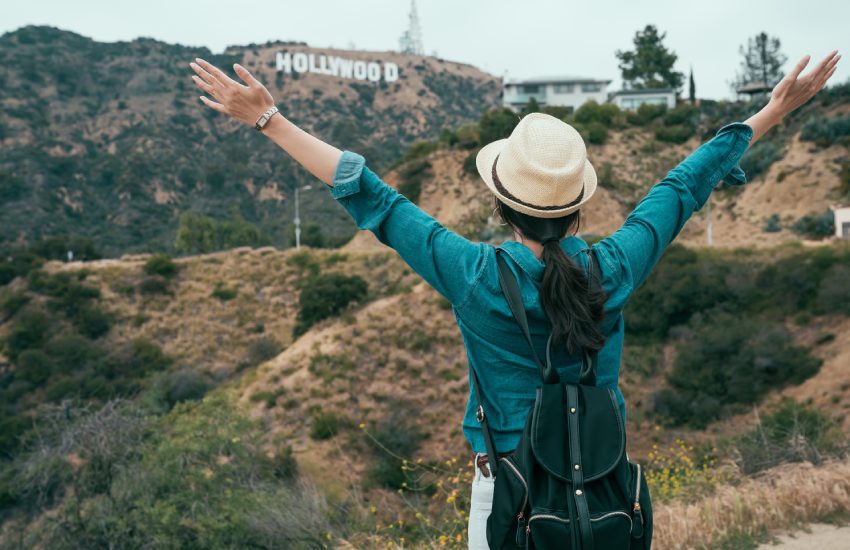 asian woman backpacker love freedom carefree hugging nature while hiking in hollywood hills enjoy fresh air. young girl traveler open arms raising standing on mountain sightseeing view of spring.asian woman backpacker love freedom carefree hugging nature while hiking in hollywood hills enjoy fresh air. young girl traveler open arms raising standing on mountain sightseeing view of spring.