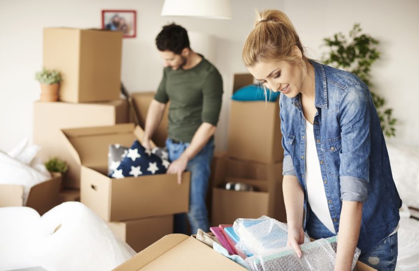 Waist up of moving house couple