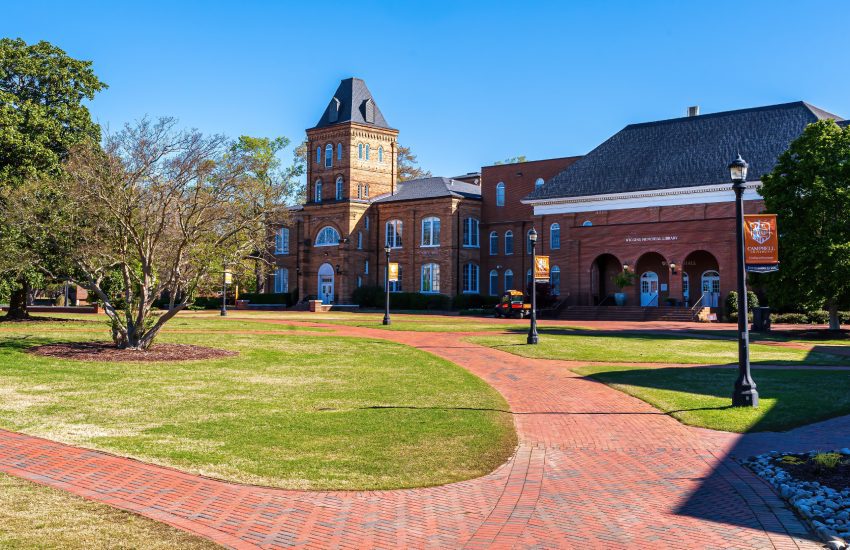 Buies Creek, North Carolina USA-04 02 2023: Colorful Orange Banners Line the Red Brick Walk Leading to the Campbell University Library.