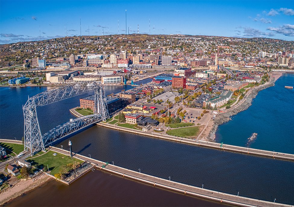 Aerial perspective of Duluth, MN with the cityscape and St. Louis River visible