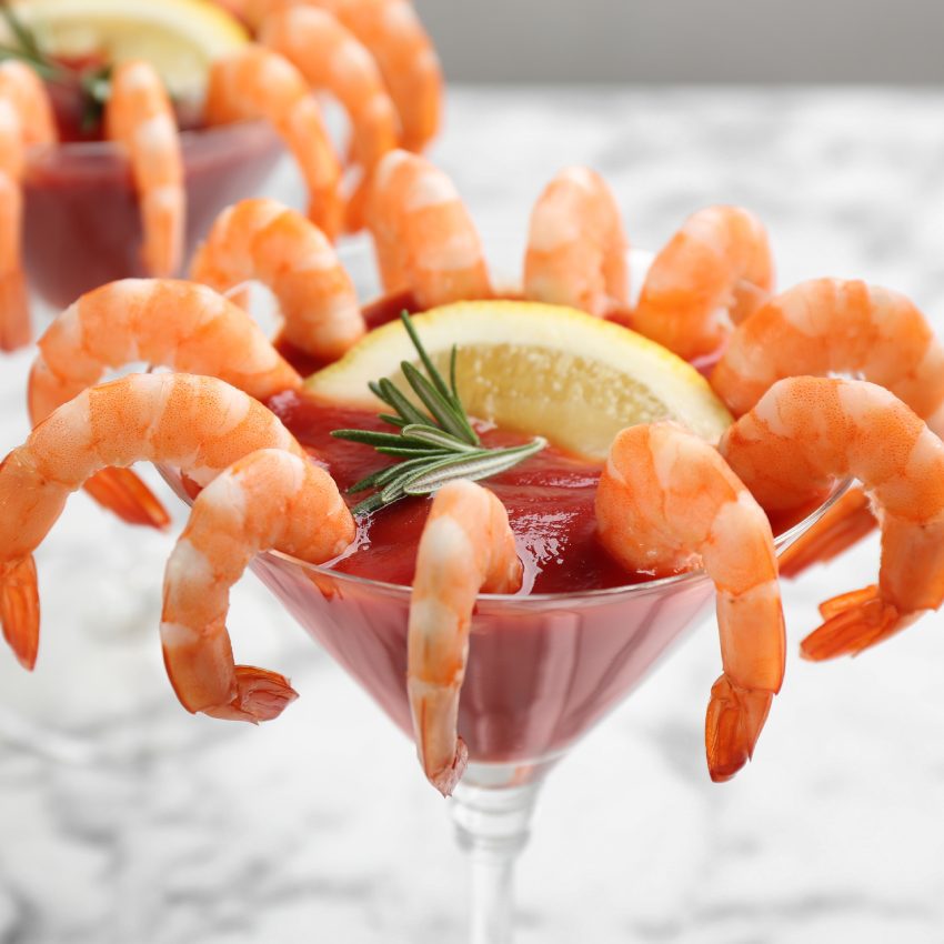 Delicious shrimp cocktail with tomato sauce, closeup