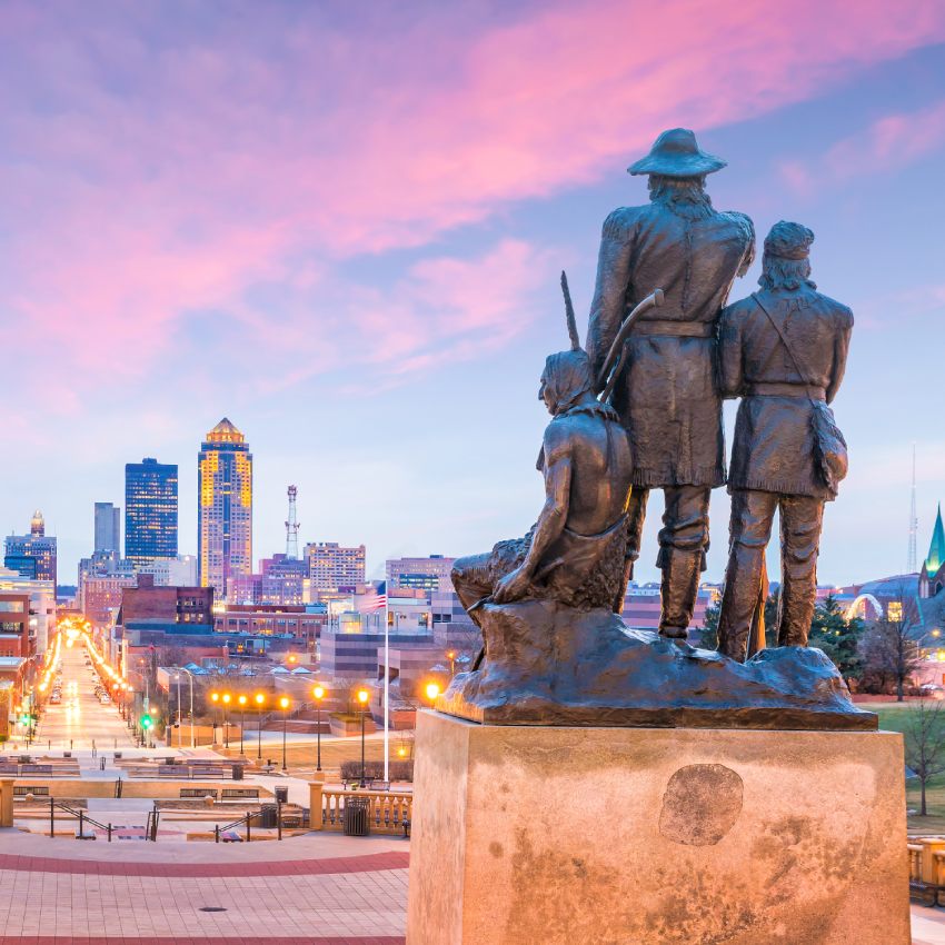 Des Moines Iowa skyline in USA with The Pioneer of the former territory statue.