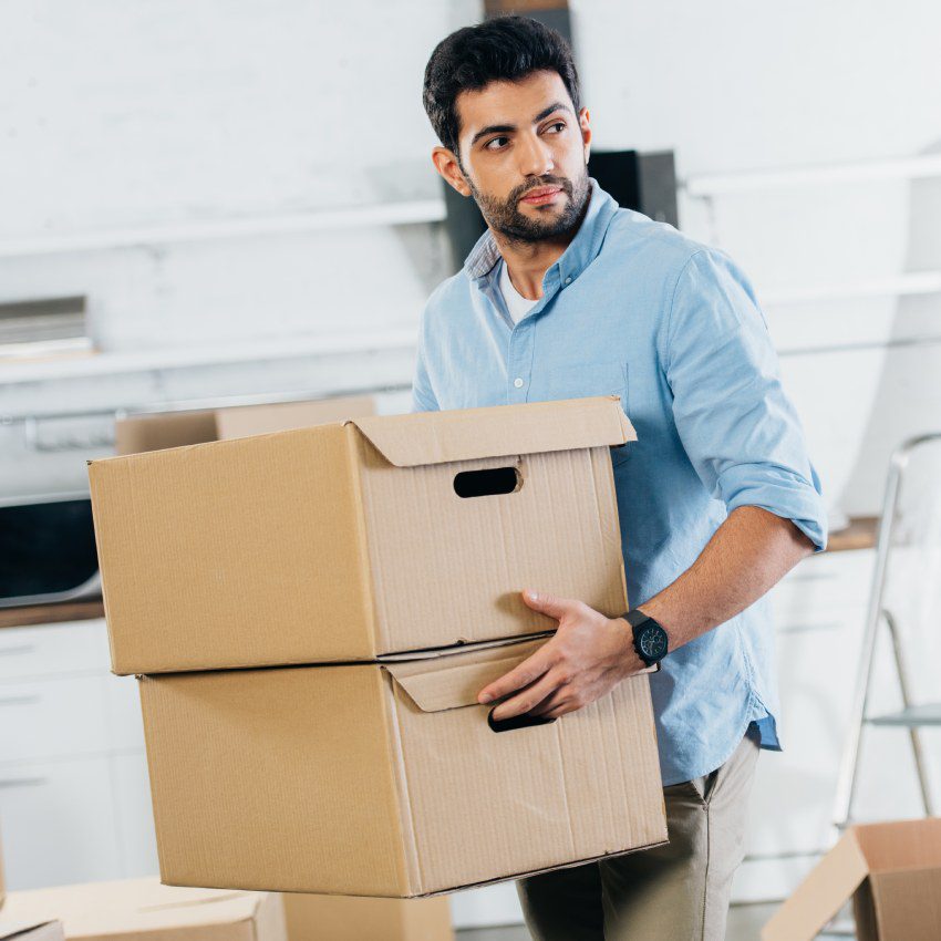 Latin man holding boxes