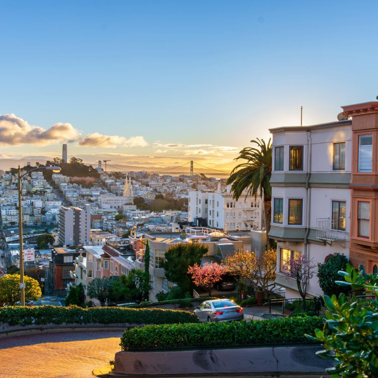 The crookedest street in the world Lombard Street. San Francisco is lightened by morning sun. View from top point of famous street.