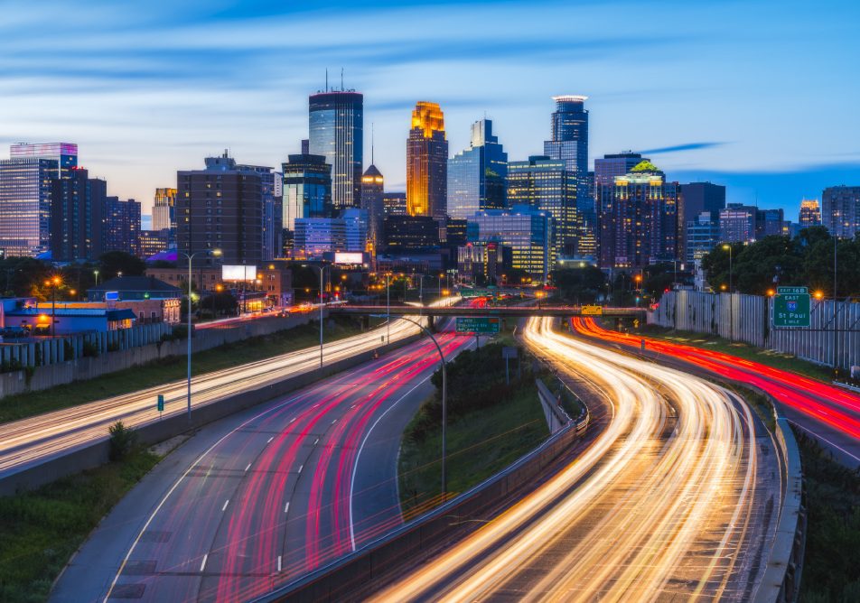 beautiful Minneapolis skyline with traffic light at night.