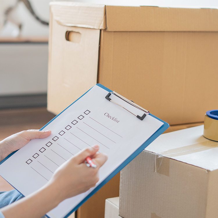 person doing checklist for moving