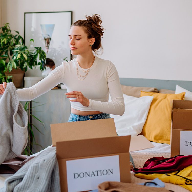 Woman doing packing with a donation box