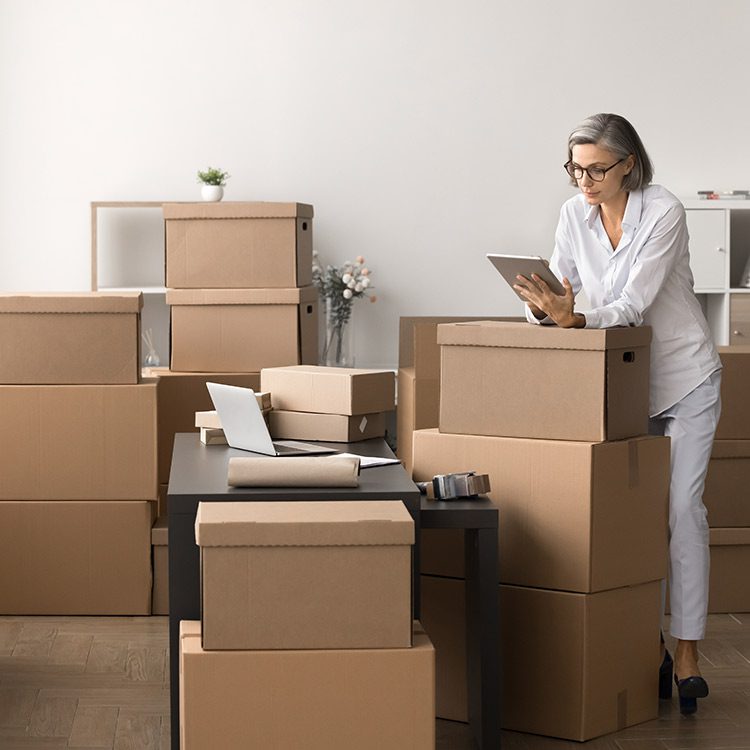 adult woman moving with boxes and resources