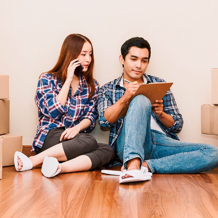 couple doing moving planning with celphone and checklist