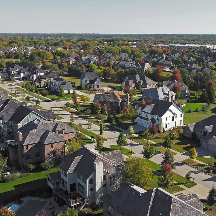 Aerial view of a residential neighborhood, showcasing homes and streets, reflecting a move from Minnesota to Illinois.