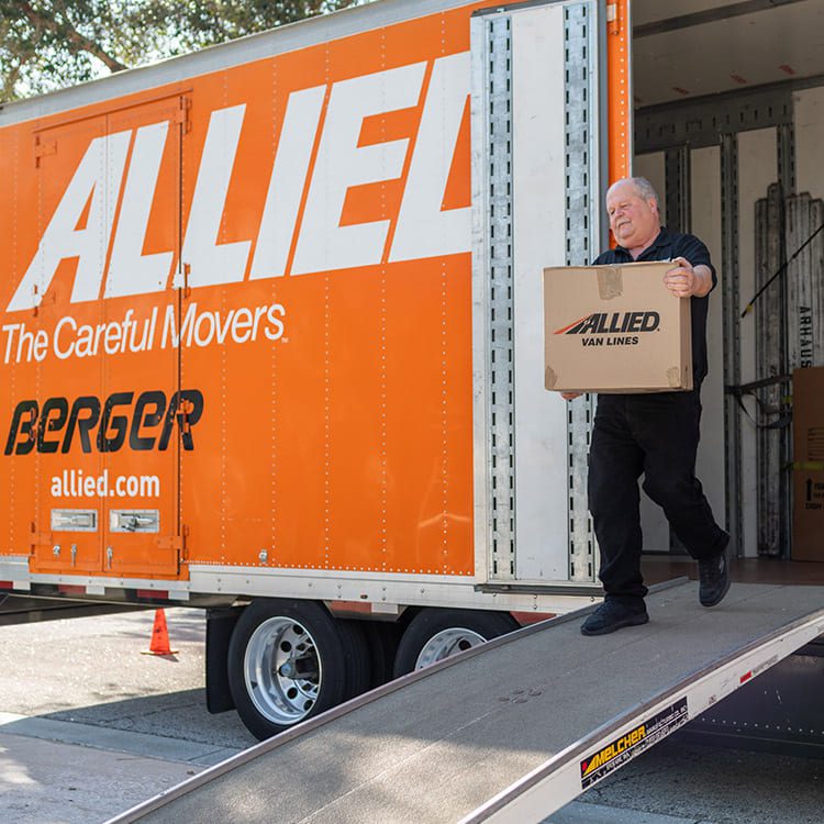 Mover downsizing box from moving truck. 