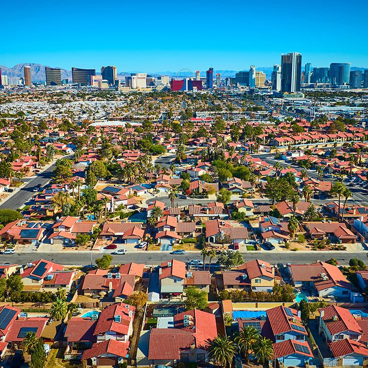 A vibrant city skyline featuring skyscrapers, representing the transition from Minneapolis to the heat of Las Vegas.