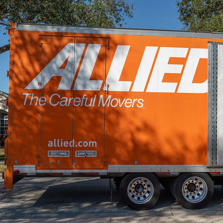 A truck marked with "Allied Moving" signifies relocation from Minneapolis to Las Vegas, facing the challenges of desert heat.