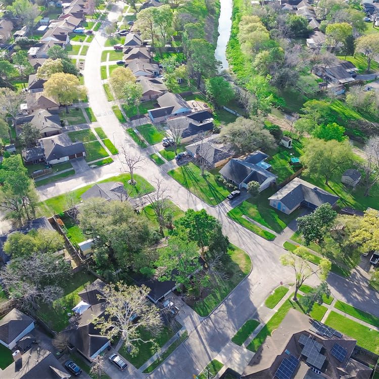 Overhead view of a Houston, Texas neighborhood, featuring houses and trees, highlighting the area's residential charm.