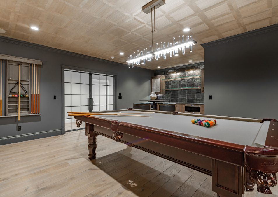 recreation room with large wooden pool table and glass doors