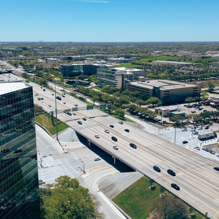 Rooftop view modern glass office buildings, corporate office headquarters in Westchase business district and busy Sam Houston Tollway and Richmond Avenue intersection, mixed use development area. USA